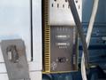 A yellow power inverter labeled 1500W showing lights and a power switch mounted inside a vehicle