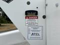 A 2018 Ford F-550 with a danger sign indicating safety instructions and an inspection sticker highlighting inspection details and contact information