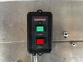 A black control panel with two buttons labeled START in green and STOP in red with the logo Honda Generators on the front