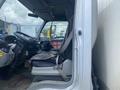 A 2012 Hino XJC720 truck cabin with a driver's seat visible featuring a headrest and a cushion with various controls and a steering wheel in the foreground