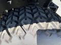 Close-up of a rugged tire tread on a 2018 Kubota RTV-X 1100 C showcasing an aggressive pattern designed for off-road traction and durability