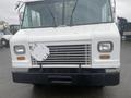 Front view of a white 2012 Ford Econoline with a grille and headlights visible and a mounted square object on the front