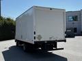 A white 2020 Hino 155 box truck with a large cargo area and a flatbed rear view showing no visible markings or logos