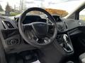 Interior view of a 2016 Ford Transit Connect featuring a steering wheel, dashboard controls, and gear shift in a modern design