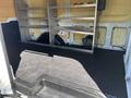 Interior of a 2016 Ford Transit van showing empty cargo space with metal shelving on one side