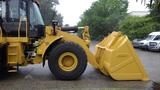 A 2019 Caterpillar 972M XE wheel loader with a large yellow bucket attached in the front