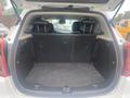 The image shows the open trunk of a 2018 Buick Encore featuring a spacious, black carpeted interior with foldable rear seats and no visible items inside