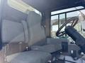 Interior of a 2015 Global Street Sweeper showing the driver's seat and steering wheel with a control panel visible