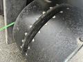 Close-up of a large, worn tire from a 2000 Hyster 120 forklift showing deep treads and a rugged surface