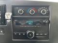 Dashboard of a 2013 Chevrolet Express featuring air conditioning controls and a radio display with a time indicator