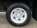 Close-up of a white steel wheel on a 2018 Isuzu NRR with a black Bridgestone tire featuring a six-bolt pattern and visible tread details