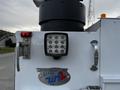 A 2016 Ford F-550 with a reflective light and a company badge indicating 55 years of service in Edmonton