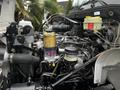 Close-up of the engine compartment of a 2020 Hino 338 showing various components including filters hoses and the engine block