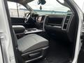 Interior view of a 2022 RAM 1500 Classic showing the driver's seat dashboard and central console with a touchscreen display and storage compartments