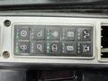 Control panel of a 2018 Doosan DL300-5 showing various light and function switches with green indicator lights