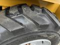 Close-up of a rugged tire from a 2024 AGT Industrial KRW23 Mini Loader showcasing deep treads and textured surface for better traction