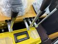 Close-up of the control levers and hydraulic connections of a 2024 AGT Industrial Yellow H13R Mini Excavator with a tool box underneath