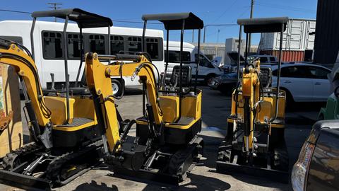 Three yellow 2021 Cael-1T Mini excavators with backfill blades and tracks, parked next to each other in a lot