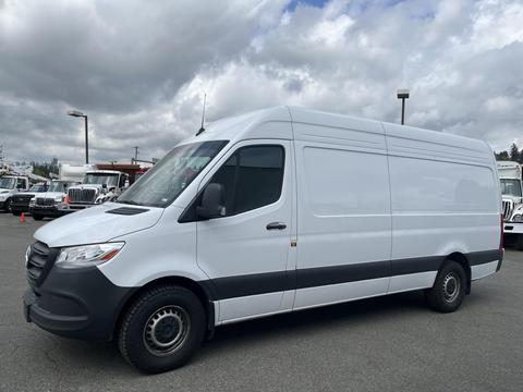 A 2025 Mercedes-Benz Sprinter van in a white exterior with a gray lower section and black wheels positioned at an angle