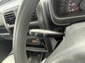 Close-up of a 2009 Suzuki Carry steering wheel with a control stalk for wipers featuring settings for mist off intermittent low and high