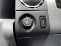 Close-up view of a control panel in a 2016 Ford F-550 featuring a dial for headlight settings and a button for fog lights