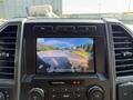 2022 Ford F600 dashboard featuring a rearview camera display showing a view of the road and surrounding area with safety instructions on the screen
