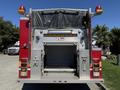 The rear view of a 2004 American LaFrance Eagle fire truck featuring a large storage compartment and two emergency lights on top