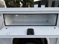 A 2018 Ford F-350 with an open storage compartment in the truck bed showcasing its interior space