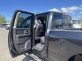 A 2011 RAM 1500 with the passenger side door open showing the interior and seating arrangements