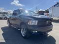 A black 2011 RAM 1500 truck parked with shiny chrome wheels and a distinctive front grille