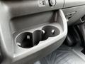 A close-up view of the cup holder in a 2022 Ford Transit with two circular compartments and a USB port above it