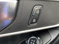 Close-up of a control panel in a 2021 Ford Explorer featuring lock and unlock buttons with a textured surface