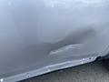 A 2006 Land Rover LR3 with a noticeable dent and scratch on the driver's side door