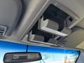 The image shows the overhead console of a 2016 Ford F-550 with an open dual cup holder and a rearview mirror in the frame