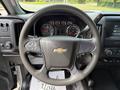 Steering wheel of a 2016 Chevrolet Silverado 2500HD featuring the Chevy logo and controls for audio and cruise settings
