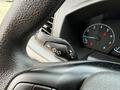 Close-up view of the steering wheel and control stalk in a 2023 Ford Transit displaying various function symbols