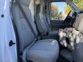 Interior of a 2019 Ford E-450 featuring two grey fabric front seats and a steering wheel with a dashboard and console visible