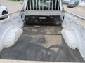 A 2017 Ford F-250 SD truck bed with a textured floor and two curved side panels showing signs of wear and dirt