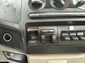 Dashboard controls of a 2008 Ford F-250 SD featuring climate controls and audio input options with various buttons and knobs