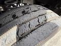 A close-up of a 2013 Ford F-550 tire showing its tread pattern and surface markings