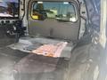 Interior view of a 2013 Ford Expedition showing a stripped cargo area with a gray floor and exposed metal surfaces