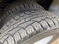 Close-up of a rugged tire from a 2015 Ford F-350 SD showcasing detailed tread patterns and sturdy design