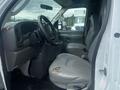 Interior of a 2004 Ford Econoline showing the driver's seat and steering wheel with visible wear on the upholstery