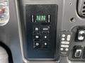 Close-up of a panel featuring buttons for selecting driving modes on a 2010 Freightliner M2 106 including options for reverse neutral and drive