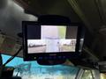 A monitor displaying a split view from cameras mounted on a 2018 Ford E-450 showing the surrounding area from different angles