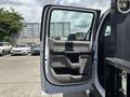 A 2017 Ford F-550 with an open driver's door showcasing the interior design and controls