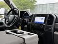 Interior view of a 2020 Ford F-550 showing the steering wheel dashboard and central console with touchscreen display and controls