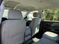 Interior of a 2016 GMC Sierra 1500 showing the back seat area with gray upholstery and a center console visible between the seats