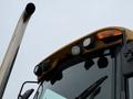 A 2011 John Deere 310SJ 4x4 Wheel Loader Extended Hoe 4 in 1 with exposed lights on the front and a visible exhaust pipe