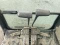 The image shows the foot pedals and levers of a 2006 Hitachi ZX200LC excavator with a dirty and worn surface